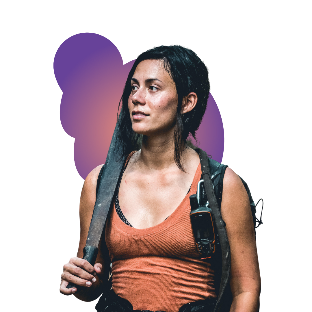 riley A smiling woman in a gray beanie hugging a black and white dog wearing a purple harness.