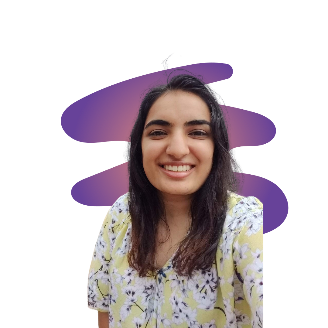 riley A smiling woman in a gray beanie hugging a black and white dog wearing a purple harness.