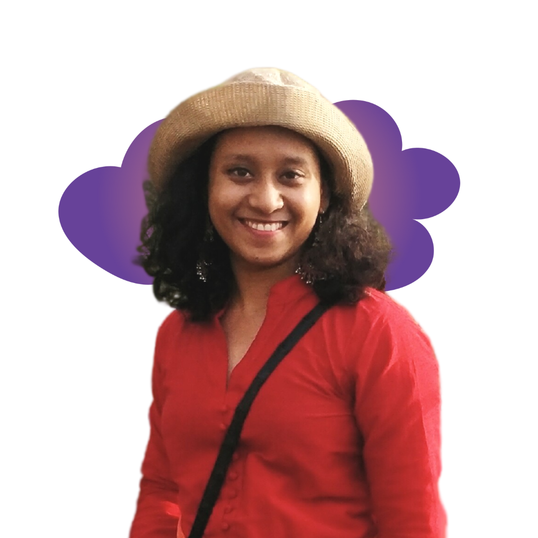 riley A smiling woman in a gray beanie hugging a black and white dog wearing a purple harness.