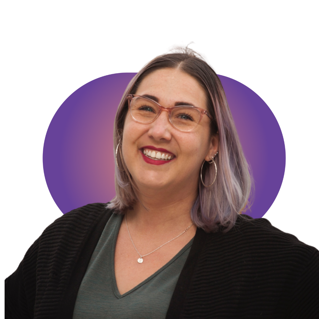 riley A smiling woman in a gray beanie hugging a black and white dog wearing a purple harness.